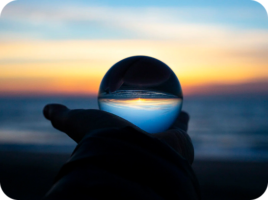 sphere in hand against landscape